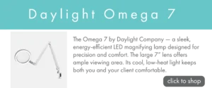 Promotional banner with a turquoise header reading ‘Daylight Omega 7.’ An image of a Daylight Omega 7 magnifying lamp appears on the left, with text reading "the omega 7 by daylight company - a sleek, energy efficient led magnifying lamp designed for precision and comford. the large 7" lens offers ample viewing area. its cool, low-head light keeps both you and your client comfortable.", on the right, along with a gray button labeled ‘click to shop.’
